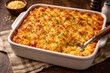© AkuAku - Golden baked macaroni and cheese casserole placed on textured wood