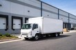 © TheWaterMeloonProjec - Delivery vehicle in white parked next to a commercial warehouse building