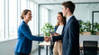 © Kaluya Stock - Successful business colleagues shaking hands and smiling in a modern office, celebrating a partnership or deal