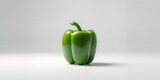 Uncut green bell pepper on plain background highlighting food freshness
