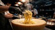 © Stocky Boi - Chef Tossing Freshly Cooked Pasta in a Wheel of Cheese in a Modern Restaurant Kitchen with Steam Rising