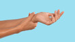 © Prostock-studio - Closeup of female arms holding painful wrist caused by prolonged work on the computer laptop. Carpal tunnel syndrome, arthritis, neurological disease concept. Numbness of the hand, blue studio wall