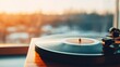 © red_orange_stock - Sunset light shines on a vinyl record spinning on a turntable