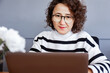 © ADDICTIVE STOCK - Woman in office using laptop for work