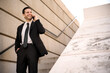 © ADDICTIVE STOCK - Businessman on phone outside in formal suit