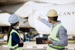 © Pang - An expert aviation mechanic leads a professional crew in a hangar, examining a jet engine to ensure safety and maintenance efficiency.