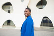 © ADDICTIVE STOCK - Confident businesswoman in blue suit smiling outdoors