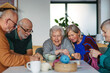© Halfpoint - Group of senior people enjoying different activities in community center.