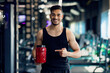 © Prostock-studio - Bodybuilding Nutrition. Happy Arab Sportsman Pointing At Red Container With Whey Powder While Posing In Modern Gym Interior, Handsome Middle Eastern Athlete Advertising Fitness Supplements