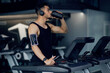 © Prostock-studio - Muscular Arab Guy Drinking Protein Cocktail From Sport Shaker While Training On Treadmill At Gym, Middle Eastern Male Athlete Jogging In Fitness Club, Enjoying Nutrition Supplements For Bodybuilding
