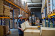 © Halfpoint - Older male warehouse worker pulling a pallet truck.
