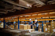 © Halfpoint - Senior woman manager and man worker working in a warehouse.