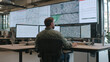 © Екатерина Чумаченко - Monitoring operations from an office setting, utilizing multi-screen display of maps and data for efficient coordination and response efforts.