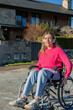 © EDER - Young woman in wheelchair moving outdoors while listening to music