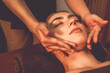 © InfiniteFlow - Caucasian woman enjoying relaxing anti-stress head massage and pampering facial beauty skin recreation leisure in warm candle lighting ambient salon spa in luxury resort or hotel. Quiescent