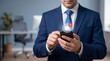 © Juwel_AI Designer - Professional businessman in blue suit holding smartphone with notification icon during office work break