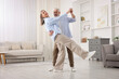 © New Africa - Lovely senior couple dancing together at home