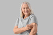 © Pixel-Shot - Mature woman applying contraceptive patch on light background. Menopause concept