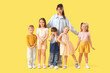 © Pixel-Shot - Group of little children with nursery teacher on yellow background
