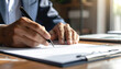 © HumblePride - Signing Contract: A close-up shot captures the focused action of a hand meticulously signing a contract with a sleek pen, symbolizing commitment and agreement.