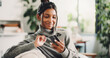 © BuyOutFelix06/peopleimages.com - House, cellphone and woman on couch, credit card and digital app for online banking. Purchase, smartphone and happy person with transactions, savings or website for subscription payment or ecommerce