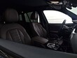 © Ruslan - Close-up of a contemporary vehicle interior showing the automatic transmission gear selector, center console, and dark fabric front seats