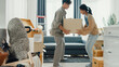 © tirachard - Young Asian couple help each other moving carton box full of stuff get some rest sit on sofa couch in living room at new house. Husband and wife move new house, Apartment Rent And Ownership Concept.