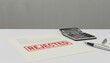 © olga_demina - Rejected document on a white desk with a calculator and pen symbolizing financial setbacks, failed applications, and the challenges of tax or loan denials