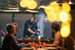 © .shock - Professional Restaurant Chef Cooking Meat with Flambe Technique at Table for Guests