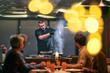 © .shock - Professional Restaurant Chef Cooking Meat with Flambe Technique at Table for Guests