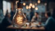 © florynstudio3 - Glowing lightbulb in focus, others blurry, suggesting brainstorming and ideas with people