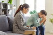 © Studio Romantic - Psychologist and depressed man meeting in counseling therapy session. Young patient sitting with gesture of stress and fatigue, anxiety, female counselor writing professional notes to help