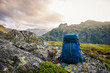 © encierro - Hiking backpack on rock during trekking in mountains. Hike and travel outdoor equipment