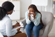 © Prostock-studio - Depressed black woman consulting psychologist, sitting in armchair and crying. Stressed African American lady with nervous breakdown letting out negative emotions at clinic