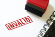 © Reza - Invalid Red stamp on a white paper notebook