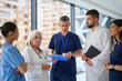 © .shock - Medical team discusses patient care strategies in a modern hospital setting during the day