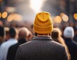 © Sondra - soft focus on individual wearing yellow beanie amidst crowd creating depth and intrigue
