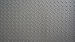 © Liada - Gray metallic diamond plate texture with repetitive raised pattern
