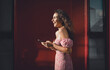 © BullRun - Laughing Hispanic woman types on smartphone while walking, reflecting joy, personal freedom, and real-time communication in a mobile, tech-driven freelance lifestyle under bright sunlight.