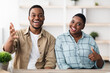 © Prostock-studio - Cheerful Black Couple Talking And Smiling To Camera Gesturing Thumbs Up Communicating Online Via Video Call Sitting At Home. Portrait Of Happy Customers Gesturing Like. Selective Focus