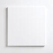 © bestimagestock - A pristine white square table features a blank sheet of paper neatly placed in the center, inviting creativity and ideas to flow freely.