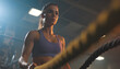 © Oleksiy - Active motivated female athlete training in gym, having a crossfit session with battle ropes, achieving goals enjoying healthy lifestyle