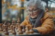 © kristina - An older woman playing chess.