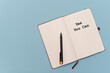 © Татьяна Зернова - An open notebook with a black pen resting on its pages. The words 'Yes You Can' are printed in bold on the left page. The background is a light blue color.