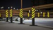 © Kartika Studio - High visibility reflective traffic barriers with yellow and black stripes stand along an asphalt road at night with red lights on top