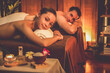 © InfiniteFlow - Caucasian couple customer enjoying relaxing anti-stress spa massage and pampering with beauty skin recreation leisure in warm candle lighting ambient salon spa at luxury resort or hotel. Quiescent