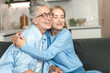 © brizmaker - Elderly mother and adult daughter enjoy a joyful moment in their cozy home