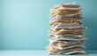 © miss irine - Tall messy stack of papers, documents on office desk. Disorganized files piled high represent workload, administrative chaos. Paper clutter needs organizing for better productivity, business
