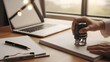 © Homestock Studio - Close-up of a person stamping a document on a desk with a laptop.