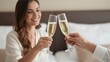 © Aliaksandr - A young Hispanic woman with long brown hair smiles while toasting with a glass of champagne. A hand reaches in from the side holding another glass.